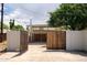 Long driveway to the covered carport in the backyard with metal and wooden gate at 356 W Roma Ave, Phoenix, AZ 85013