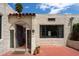 Charming home featuring stucco exterior, a red tile roof detail, black trimmed windows, and a welcoming entryway at 356 W Roma Ave, Phoenix, AZ 85013