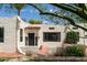 Charming home featuring stucco exterior, a red tile roof detail, black trimmed windows, and well-manicured landscaping at 356 W Roma Ave, Phoenix, AZ 85013