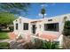 Charming home featuring stucco exterior, a red tile roof detail, black trimmed windows, and well-manicured landscaping at 356 W Roma Ave, Phoenix, AZ 85013