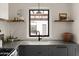 Kitchen sink with backyard view and open wood shelving at 356 W Roma Ave, Phoenix, AZ 85013