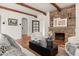 Charming living room with a stone fireplace, wooden beams, and comfortable seating creating a cozy atmosphere at 356 W Roma Ave, Phoenix, AZ 85013