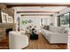 Bright living room with a stone fireplace, exposed wood beam ceiling, and neutral furnishings at 356 W Roma Ave, Phoenix, AZ 85013