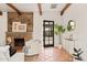 Beautiful living room featuring a stone fireplace, an armchair and open access to the outdoor space at 356 W Roma Ave, Phoenix, AZ 85013