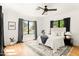Bright main bedroom with wood floors, rug, and large window at 356 W Roma Ave, Phoenix, AZ 85013