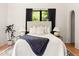 Bright bedroom with hardwood floors, a cozy rug, and a large window at 356 W Roma Ave, Phoenix, AZ 85013