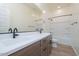 Bright bathroom featuring a double sink vanity with modern fixtures and a tiled floor at 3824 W Lodge Dr, Laveen, AZ 85339