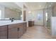 Modern bathroom with double vanities, a glass shower, and wood-look tile floors for a spa-like feel at 3824 W Lodge Dr, Laveen, AZ 85339