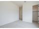 Bedroom with neutral carpet, white walls, and a door leading to a closet at 3824 W Lodge Dr, Laveen, AZ 85339