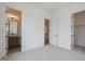 Bedroom with neutral walls, carpet, en-suite bathroom, and walk-in closet at 3824 W Lodge Dr, Laveen, AZ 85339