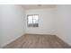 Bedroom with a window and wood-look tile flooring offering natural light and a modern aesthetic at 3824 W Lodge Dr, Laveen, AZ 85339