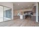 Open concept kitchen with island, stainless appliances and gray cabinetry with sliding doors to outdoor space at 3824 W Lodge Dr, Laveen, AZ 85339