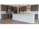 Modern kitchen featuring stainless steel appliances, a large island with counter seating, and subway tile backsplash at 3824 W Lodge Dr, Laveen, AZ 85339