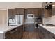 Kitchen featuring stainless steel appliances, gray cabinets, a white island, and tiled floors at 3824 W Lodge Dr, Laveen, AZ 85339