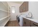 Well-organized laundry room featuring storage shelves, modern washer and dryer, and a convenient sink at 3824 W Lodge Dr, Laveen, AZ 85339