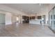 Spacious living room featuring an open layout, tile floors, and a modern kitchen with stainless steel appliances at 3824 W Lodge Dr, Laveen, AZ 85339