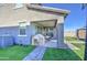 Backyard features a covered patio and lush artificial turf, offering a beautiful and low-maintenance outdoor space at 4507 S 119Th Dr, Avondale, AZ 85323