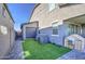 Backyard showcasing the garage, turf, and a pet house with ample space and storage solutions at 4507 S 119Th Dr, Avondale, AZ 85323