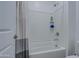 Clean, well-maintained bathroom featuring a shower-tub combination and white tile at 4507 S 119Th Dr, Avondale, AZ 85323