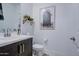 Modern half bath featuring a wood cabinet, unique decor, and custom finishes at 4507 S 119Th Dr, Avondale, AZ 85323