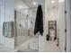 Bathroom featuring a glass-enclosed shower, tiled walls, and a separate toilet area at 4507 S 119Th Dr, Avondale, AZ 85323