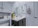 Bright bathroom featuring a modern vanity with white countertop and dark wood cabinets for a contemporary look at 4507 S 119Th Dr, Avondale, AZ 85323