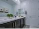 Bathroom featuring double vanity, decor, a large mirror, and neutral color scheme at 4507 S 119Th Dr, Avondale, AZ 85323