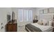 Bright bedroom with modern shades, a plush bed, stylish nightstand, and eye-catching wall decor at 4507 S 119Th Dr, Avondale, AZ 85323