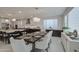 Large dining area with sleek table and modern lighting adjacent to the spacious kitchen at 4507 S 119Th Dr, Avondale, AZ 85323