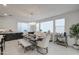 Open dining area with modern chandelier and large windows bringing in plenty of light at 4507 S 119Th Dr, Avondale, AZ 85323