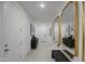 Bright hallway with stylish mirror, accent table, and tile flooring at 4507 S 119Th Dr, Avondale, AZ 85323