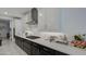 Bright kitchen features black and white cabinetry and modern stainless steel appliances at 4507 S 119Th Dr, Avondale, AZ 85323