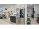 Gourmet kitchen showcasing stainless steel refrigerator and a view of the staircase and adjacent living area at 4507 S 119Th Dr, Avondale, AZ 85323