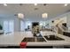 Kitchen island featuring a sink, quartz countertop, and decorative pendant lights at 4507 S 119Th Dr, Avondale, AZ 85323