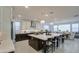 Bright, open kitchen with an island, stainless steel appliances, dark cabinets and quartz countertops at 4507 S 119Th Dr, Avondale, AZ 85323