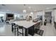 Open concept kitchen with large island, stylish chandeliers, and views into the living room at 4507 S 119Th Dr, Avondale, AZ 85323