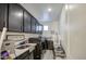 Convenient laundry room features dark cabinets, stainless steel sink, washer, and dryer at 4507 S 119Th Dr, Avondale, AZ 85323