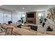 Bright living room with a fireplace, large sectional sofa, decorative lighting, and black accent rug at 4507 S 119Th Dr, Avondale, AZ 85323