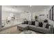 Comfortable living room with plush gray sectional, decorative pillows, and modern lighting fixtures at 4507 S 119Th Dr, Avondale, AZ 85323