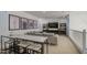 Open concept living room with a gray sofa, dark wood shelving and white marble table with chairs at 4507 S 119Th Dr, Avondale, AZ 85323
