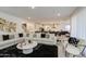 Open floor plan featuring a spacious living room seamlessly flowing into the kitchen and dining area at 4507 S 119Th Dr, Avondale, AZ 85323