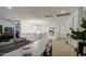 Bright living room showcasing a gray sofa, modern lighting fixture, and white walls and trim at 4507 S 119Th Dr, Avondale, AZ 85323