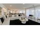 Open floor plan featuring a spacious living room seamlessly flowing into the kitchen and dining area at 4507 S 119Th Dr, Avondale, AZ 85323