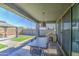 Covered patio with outdoor dining area and view of the turfed backyard; perfect for entertaining and relaxing at 4507 S 119Th Dr, Avondale, AZ 85323