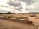 Expansive backyard featuring gravel landscaping and a large brick planter, perfect for outdoor enjoyment at 4537 E Emelita Ave, Mesa, AZ 85206