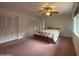 Bedroom with ceiling fan, double closets and view of adjoining room at 4537 E Emelita Ave, Mesa, AZ 85206