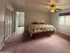 Bedroom with bed, ceiling fan, and view of an adjoining room at 4537 E Emelita Ave, Mesa, AZ 85206