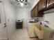 Laundry room featuring tile floors, utility sink, washer, and dryer at 4537 E Emelita Ave, Mesa, AZ 85206