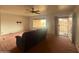 Bright living room with a ceiling fan, a large window, and easy access to the entry at 4537 E Emelita Ave, Mesa, AZ 85206