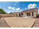 Picture of a backyard with a covered patio, neutral colored walls, a block fence, and low-maintenance landscaping at 4891 E Meadow Mist Ln, San Tan Valley, AZ 85140